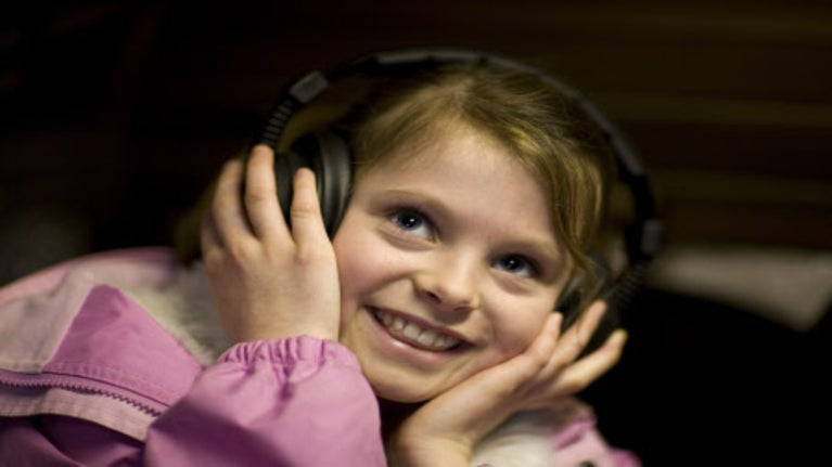 Child listening through headphones at the National Trust